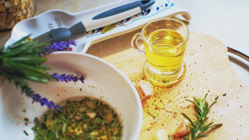 Bol de marinade à l'huile d'olive, citron et ail écrasé sur un plan de travail