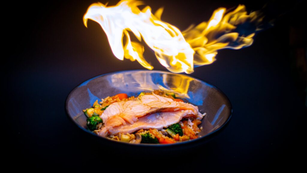 Plat de riz sauté qui flambe dans une poêle à feu vif